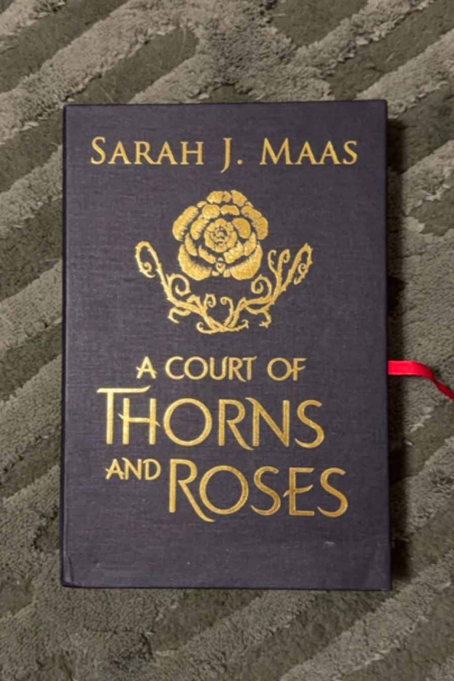 A Court of Thorns and Roses — Hardcover · New